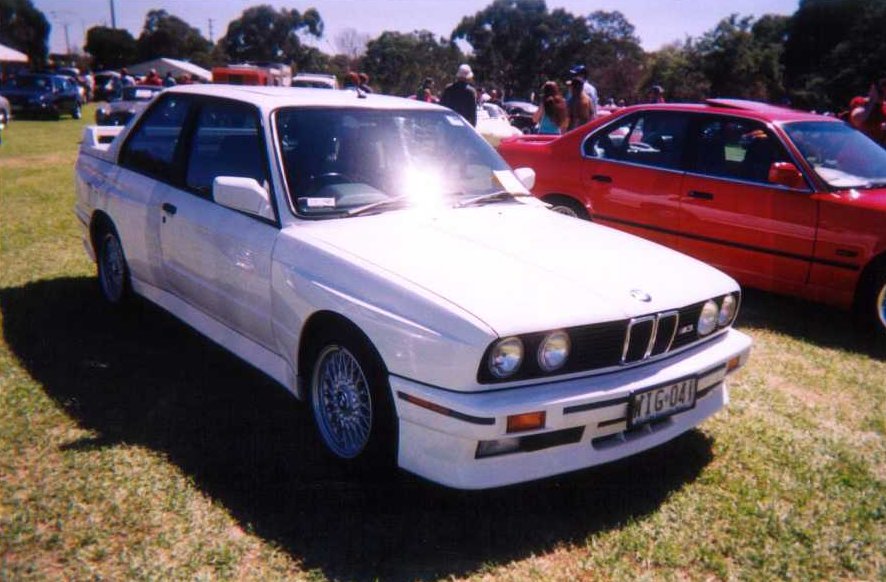 BMW E30 M3 coupe parked at a car event